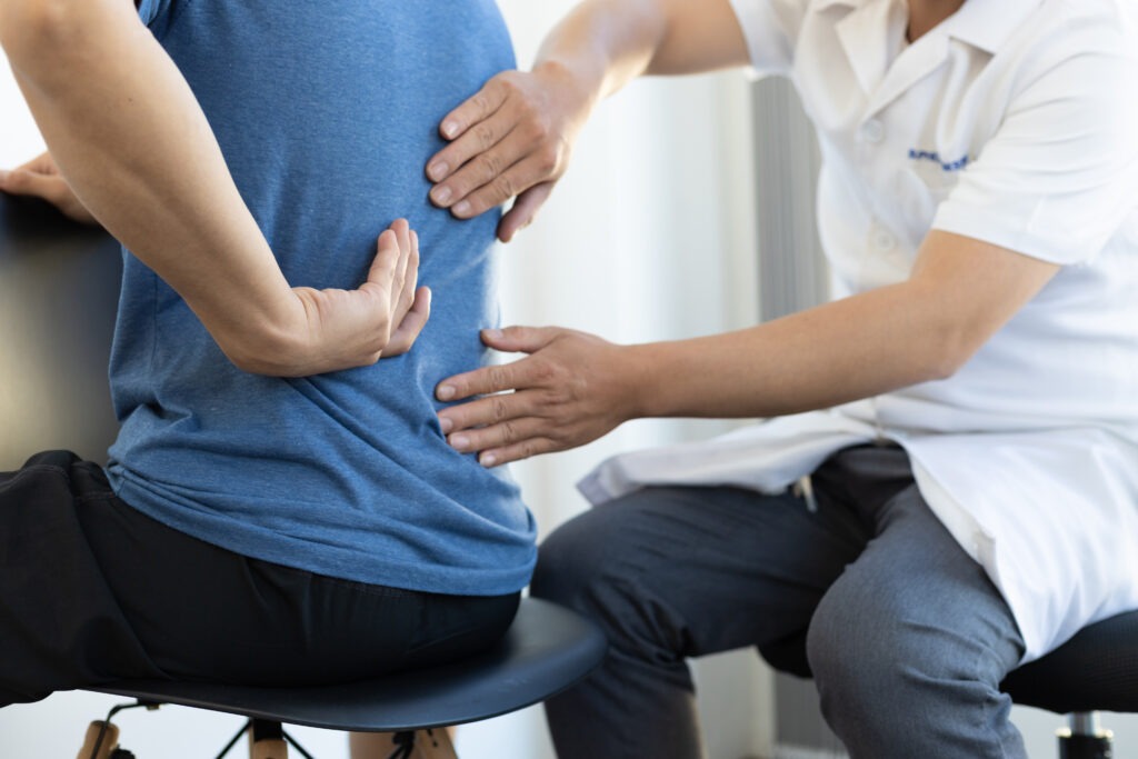 the doctor is diagnosing the patient s back pain 2023 11 27 05 22 43 utc