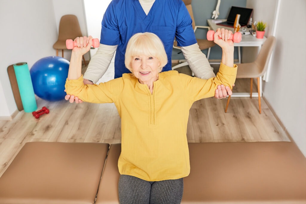 physiotherapist helping a senior woman to lift dum 2025 04 01 20 38 48 utc